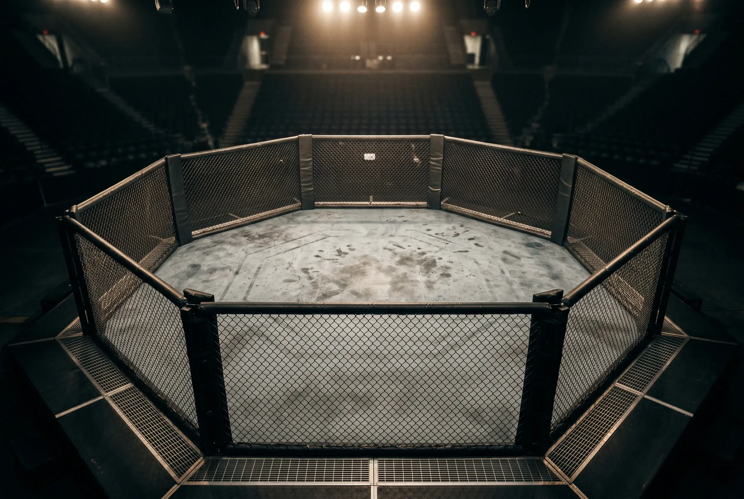Empty UFC octagon viewed from overhead under arena spotlights