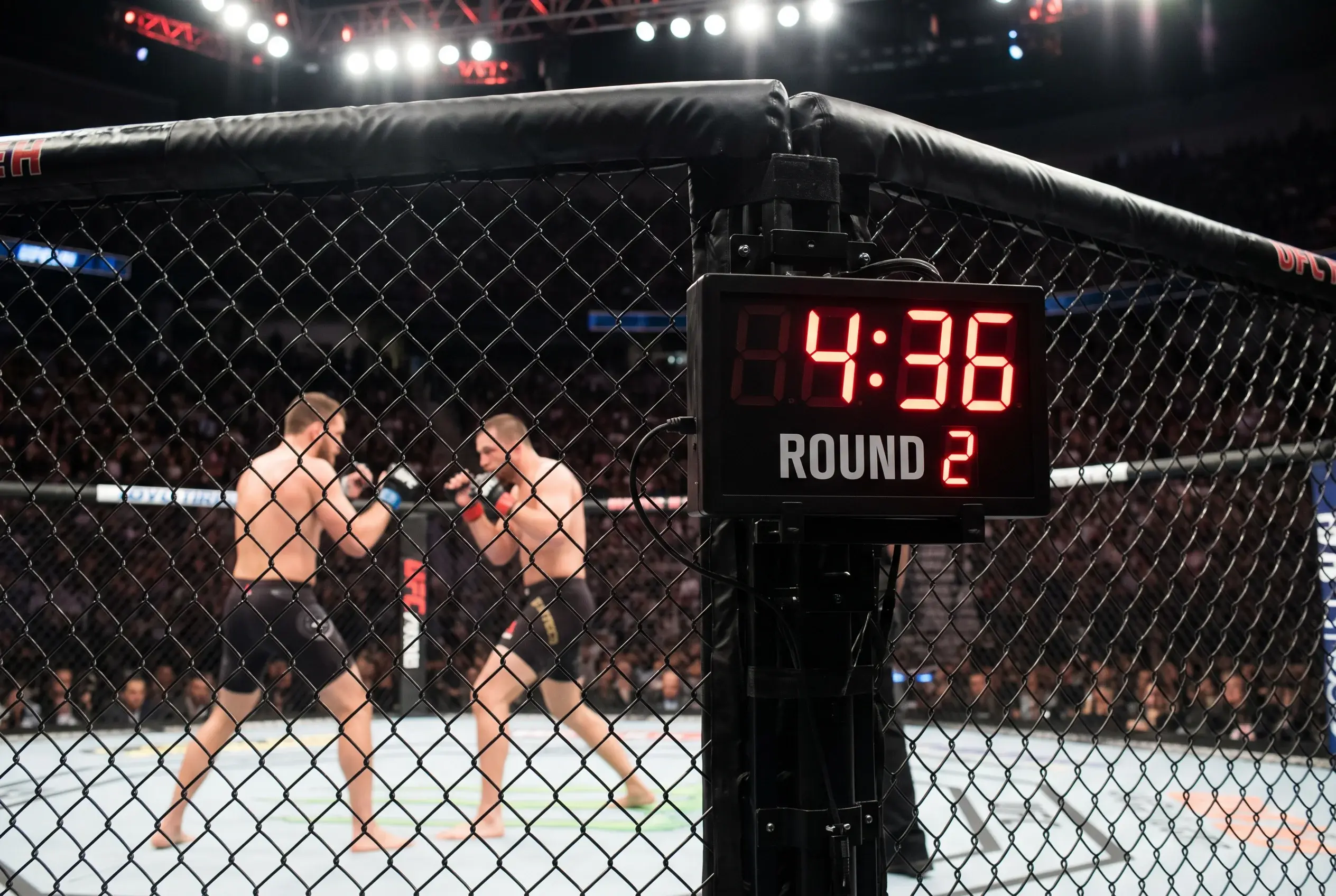 UFC arena cage-side clock graphic showing a round timer with over and under threshold markers highlighted across the display