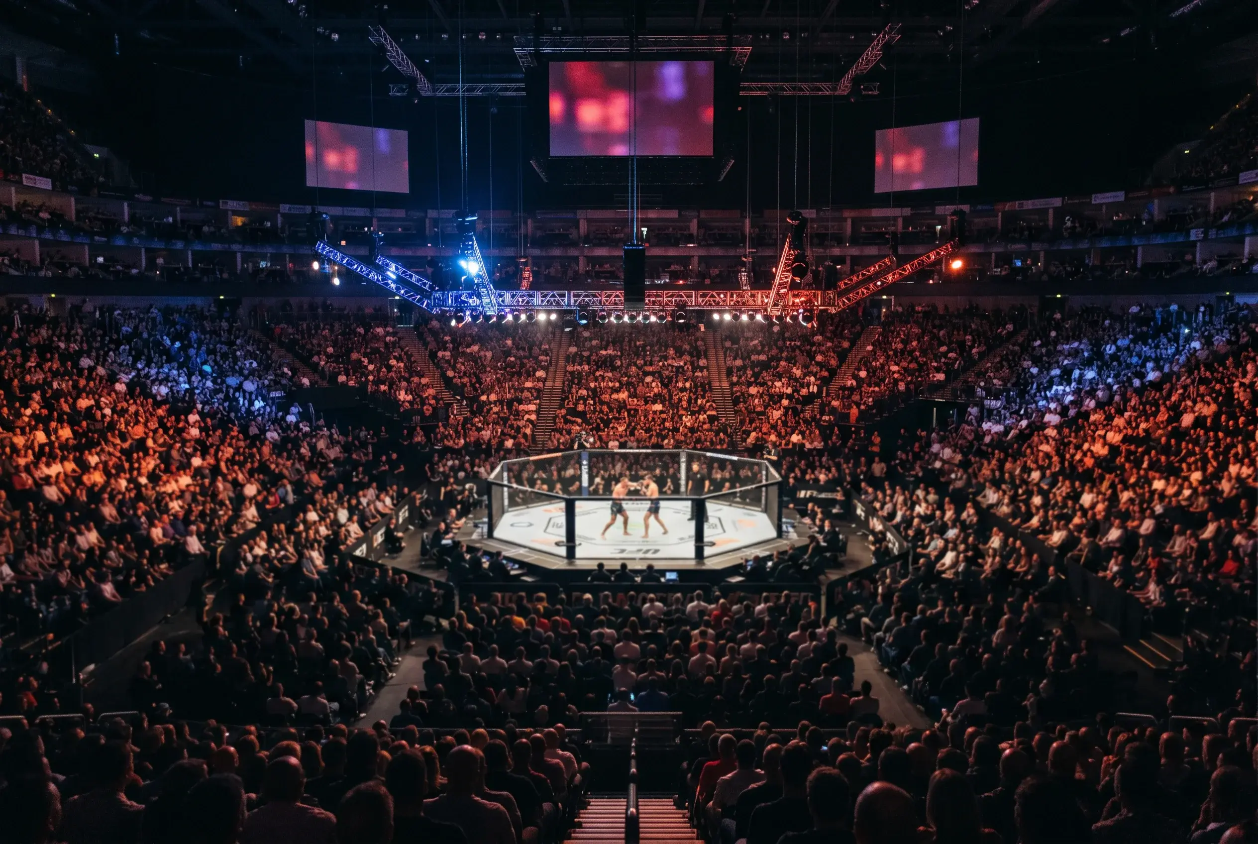 UFC fight night atmosphere inside a packed UK arena, mixed martial arts crowd watching the Octagon